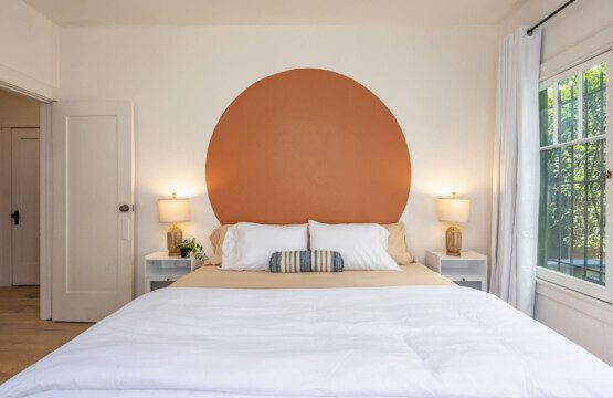 A calm, inviting bedroom with a warm statement wall and soft lighting for restful nights. Designed for comfort and ease, it’s a space you’ll look forward to coming home to each day.