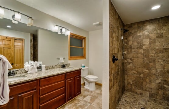 Spacious ensuite bathroom with shower, including a built-in bench for added comfort.
