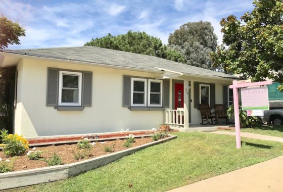 Charming single-story home at 7468 Ohio Place in La Mesa featuring a bright red front door, grey shutters, and a large shade tree in the front yard.