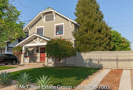 a two story craftsman historic home in south park san diego with a large tree on the right side
