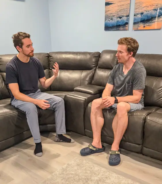 Brendan Marshall RP(Q) sitting on his markham office couch speaking with his male client with Anxiety and ADHD