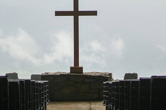 pexels-photo-9422339-9422339 A peaceful church interior featuring a prominent cross symbol, evoking spirituality.