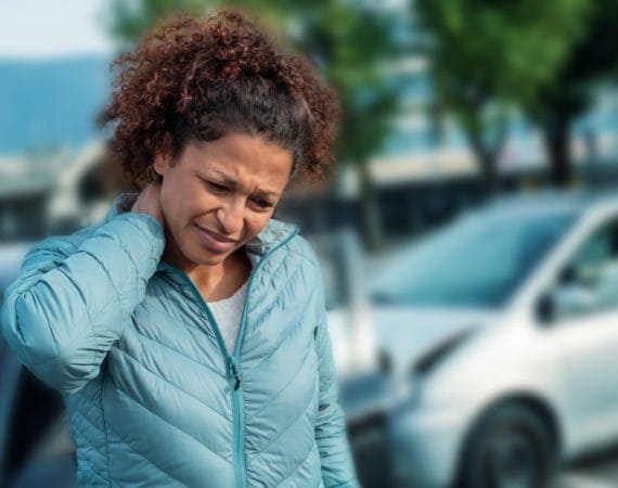 Woman suffering neck pain after car accident