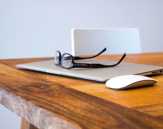 Laptop and glasses representing taxable personal injury settlements