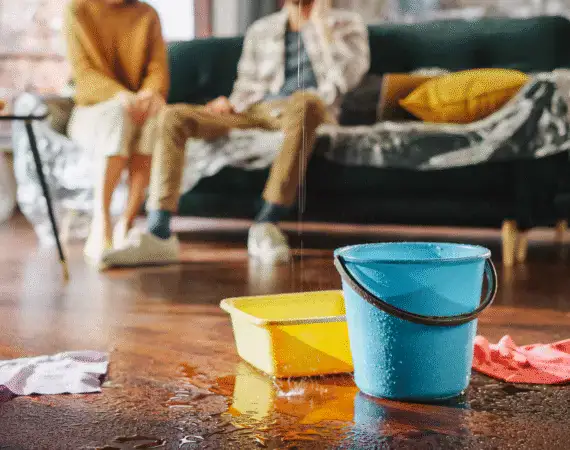 Buckets catching water from a ceiling leak in a Houston home – Texas Bulldog Property Damage Case