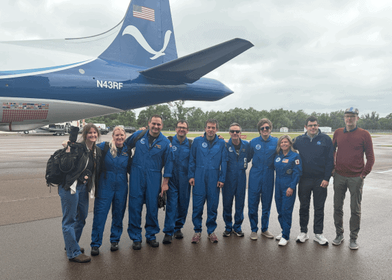 Black Swift Technologies and NOAA Hurricane Hunters standing in front of the NOAA P-3 Orion Hurricane Hunter Aircraft