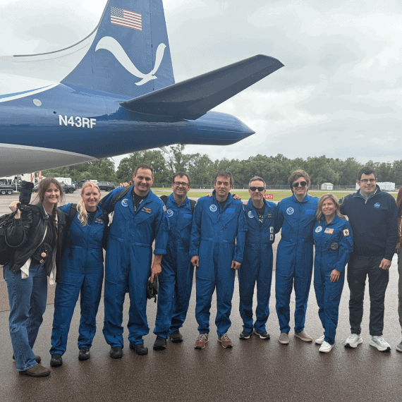 Black Swift Technologies and NOAA Hurricane Hunters standing in front of the NOAA P-3 Orion Hurricane Hunter Aircraft