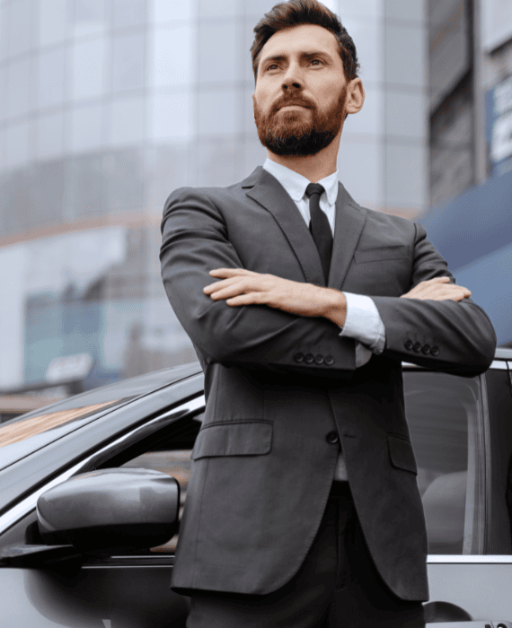 Professional safe driver in Dubai standing next to luxury car