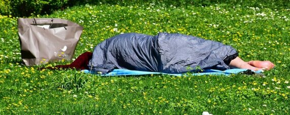 Tarp used as blanket and shelter