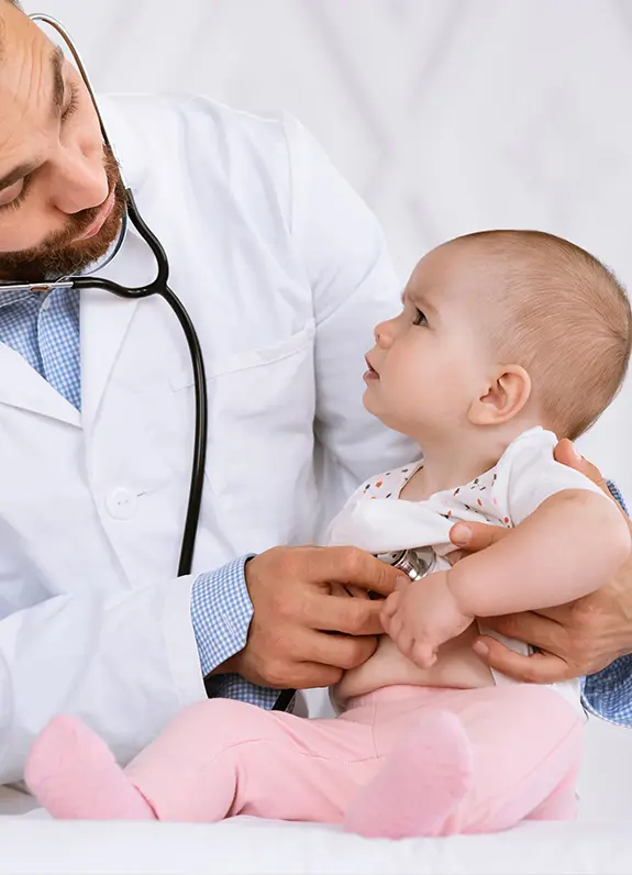Doctor examining a baby