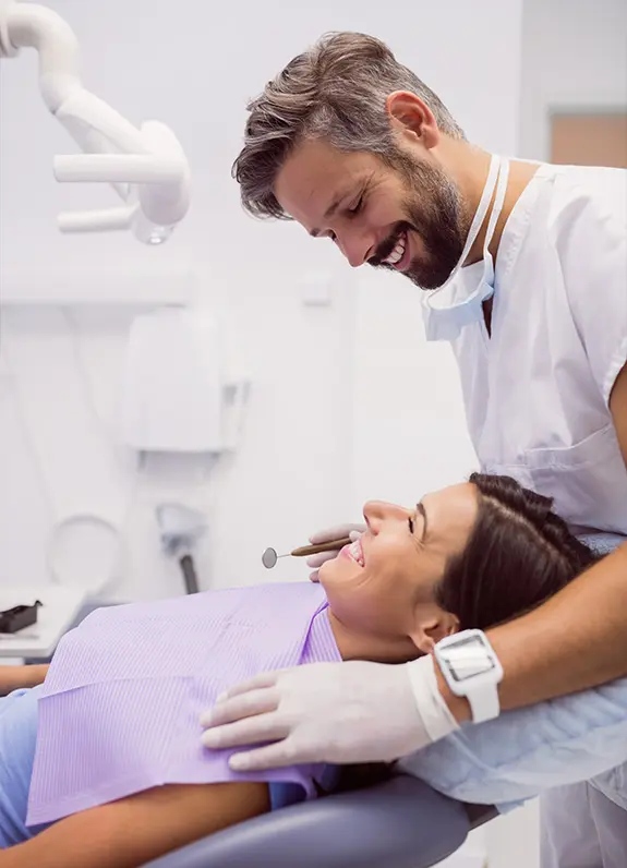 Dentist checking female patient’s teeth