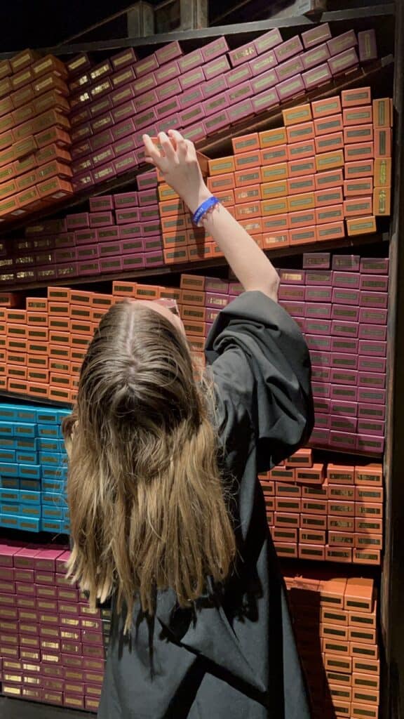 Pink and orange shoeboxes on shelves at 407 Vacation Co. store.