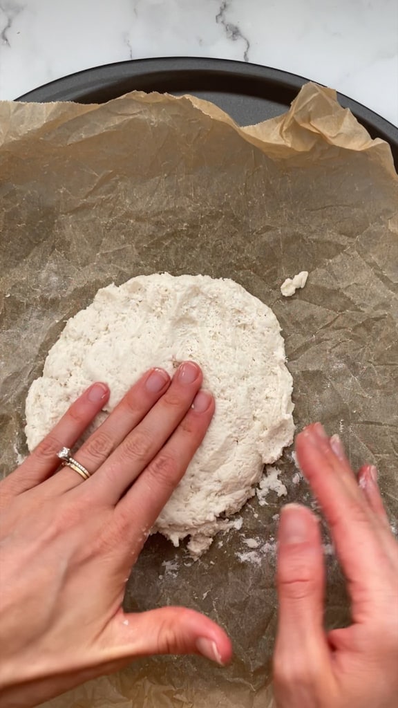 Seasoning the dough and flattening it. 