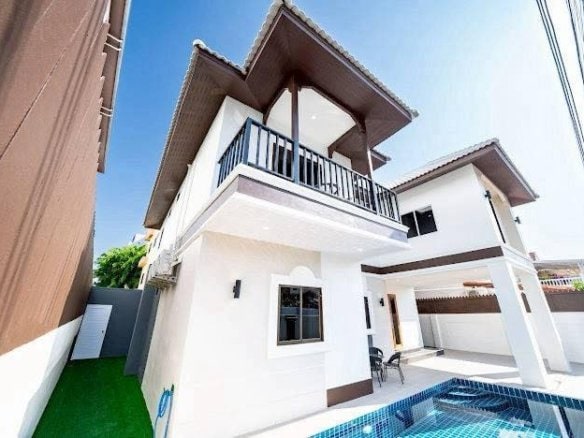 Modern white two-story house with pool and manicured lawn