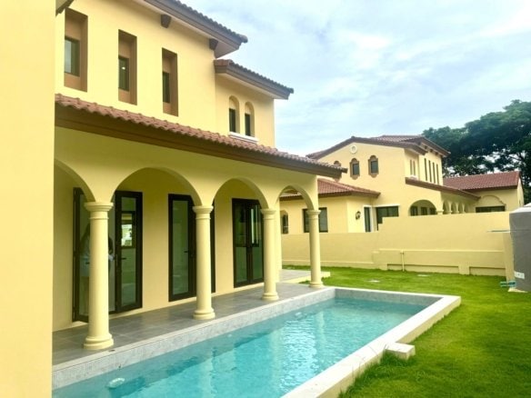 Luxurious yellow Mediterranean villa with arched colonnade and swimming pool