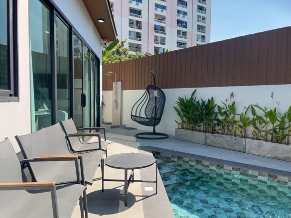Modern rooftop terrace with lounge chairs, hanging swing, and small pool