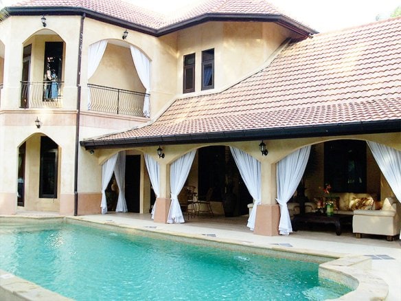 Luxury Mediterranean villa with swimming pool and covered patio area