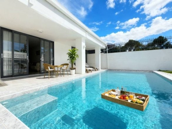 Modern luxury home with swimming pool and outdoor patio seating area
