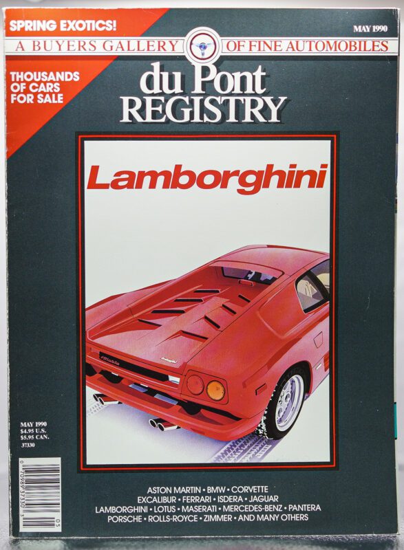 Cover Cars: May 1990 duPont REGISTRY magazine featuring a striking red Lamborghini, with its rear view and branding highlighted—an iconic issue celebrating automotive excellence.