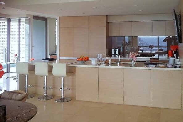 Custom made kitchen in Hyde park. Made from New Age Navurban Oak Veneer with integrated appliances. With Blum push touch draws and doors give this kitchen a clean and modem look. The stone bench top with breakfast bar and water fall edge. Custom made joinery and cabinet making.