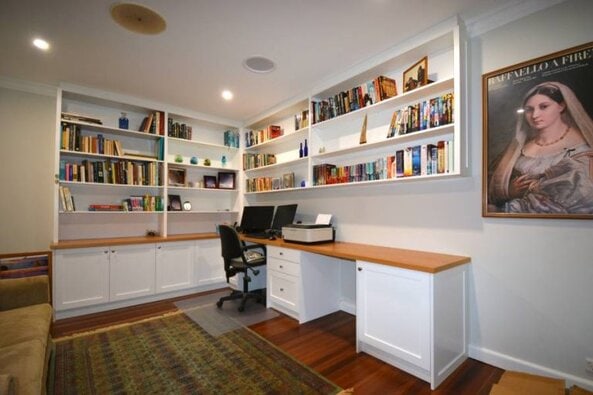 This two-seater home office with built-in bookcases was built for a customer in Pymble with shaker-style doors and timber oak benchtop. Finished in satin white ploy paint with clear satin on the bench top using Blum hinges and draw runner.