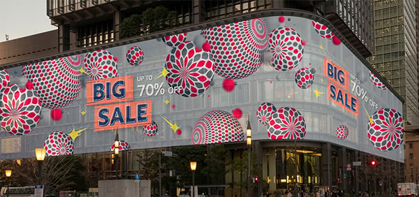 LED mesh display installed on a shopping mall facade, demonstrating appropriate pixel pitch for medium viewing distances with clear, vibrant image visible to nearby shoppers