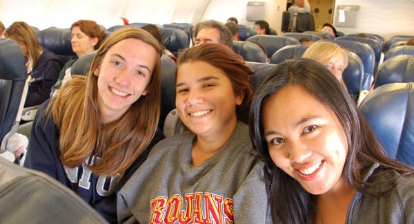 students sitting in their seats on an aircraft bound for an overnight fight europe