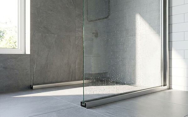 Fixed glass shower screen secured in a floor-to-ceiling aluminium channel