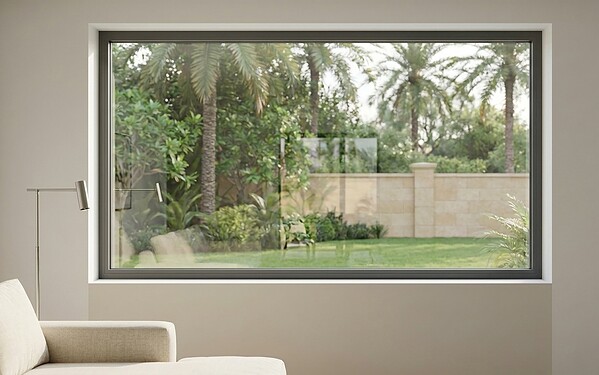 Fixed picture aluminium window framing a garden view with palm trees from inside a Dubai living room