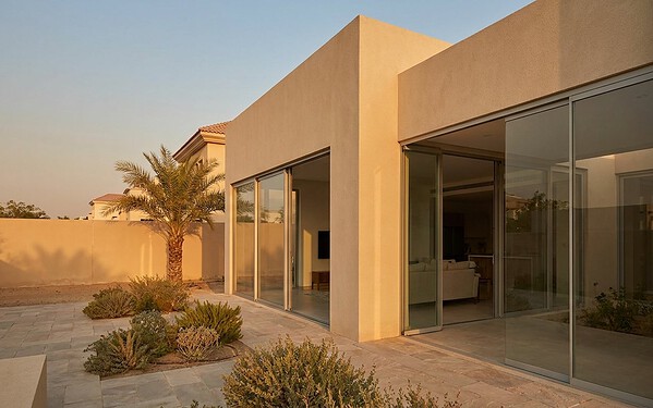 Lift-and-slide doors opening a beach villa onto a terrace on Saadiyat Island
