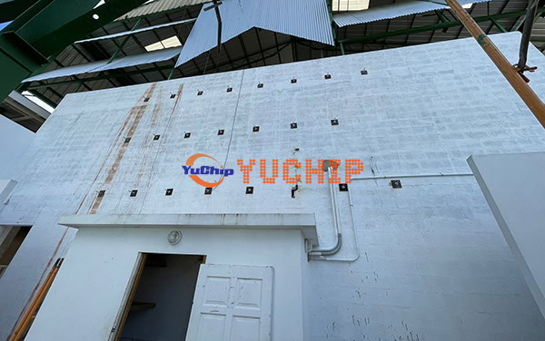White exterior wall with mounting points and conduits prepared for outdoor LED display installation at a hotel in Barbados