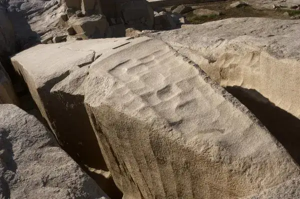 Ancient quarrying tool marks on granite beside the Aswan obelisk