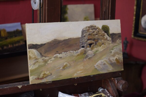 Nuracu d’Izzana oil painting displayed on an easel in Andrea Bocedi’s studio