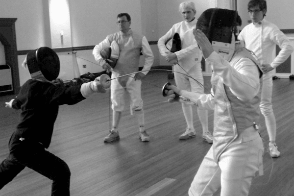 A group of fencers receiving training in coach development