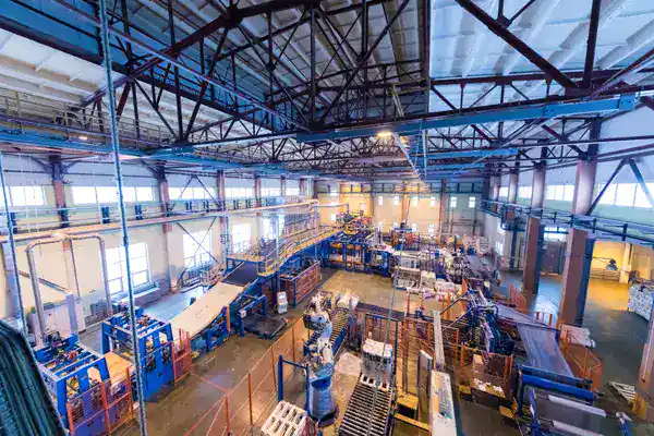 Automation manufacturing factory with advanced machinery and conveyor systems in a spacious industrial setting.