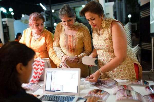 Wedding guests picking up their instant photo prints at the print station