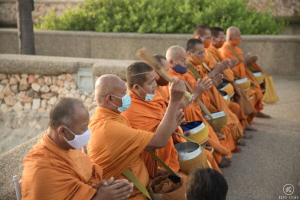 Monks in saffron robes chant a blessing along the seawall at Dusit Thani Hua Hin on the wedding morning