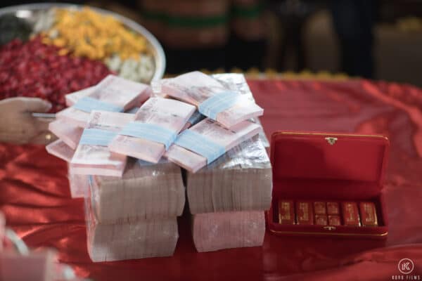 Sin Sod banknotes and engagement gold bars on a red cloth at a Thai engagement ceremony at Dusit Thani Hua Hin