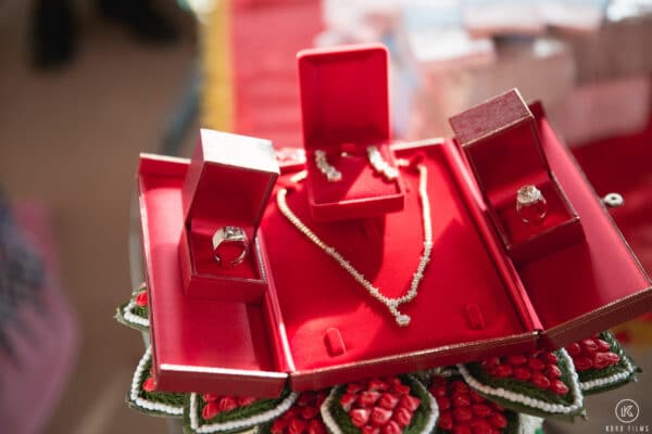 Engagement gold necklace, earrings and rings in red boxes for the Thong Mun at a Thai wedding at Dusit Thani Hua Hin