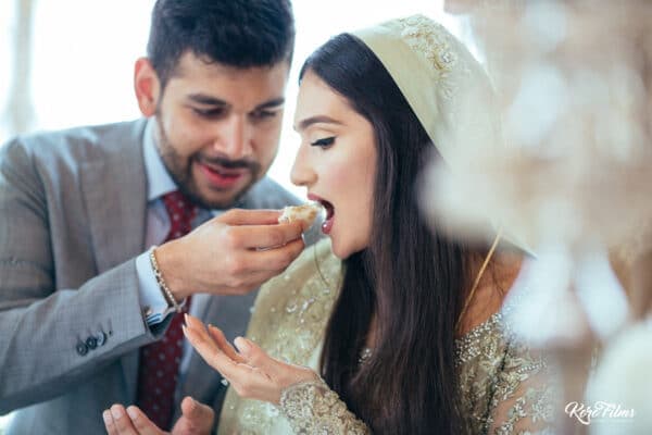 The groom feeds the bride a sweet after their Nikah in Hua Hin