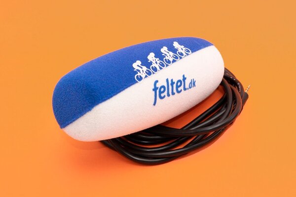 Blue and white feltet.dk branded foam microphone windshield with decorative pattern on orange background with cable