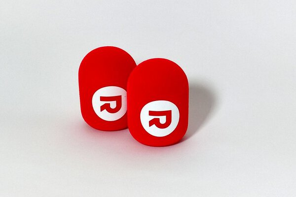 Red branded studio microphone windshields with white R logo - cylindrical foam covers
