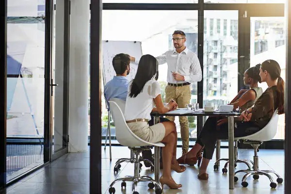 workers in a conference room discussing fiscal planning