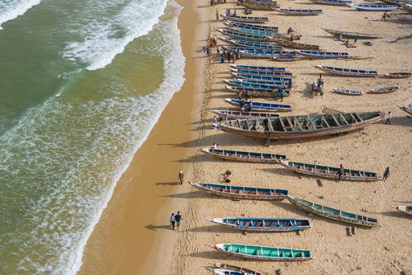 Aerial view of fishing village, pirogues fishing boats in Kayar, Senegal.  Photo made by drone from above. Africa Landscapes.