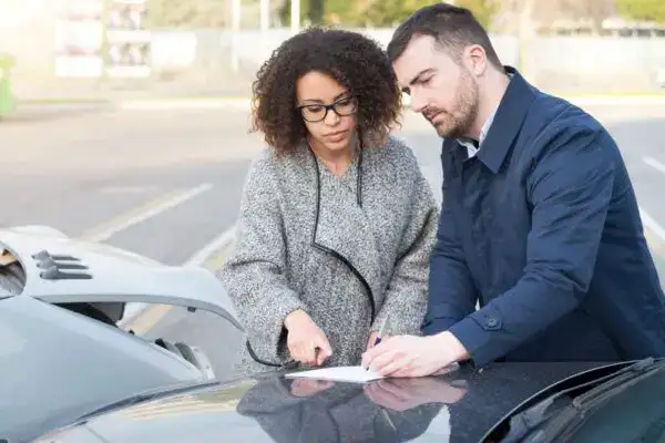 Texas driver reviewing car insurance policy coverage in Houston, considering liability and uninsured motorist protection.