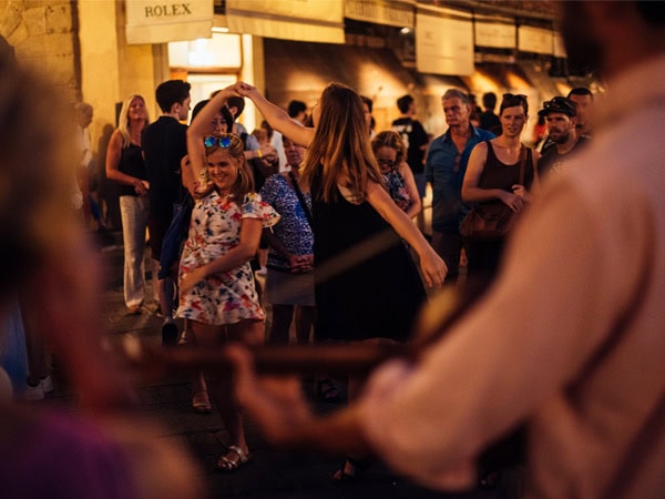 Students dancing at night to local musicians