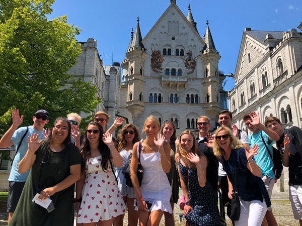 ACIS group waving in front of Neuschwanstein Castle