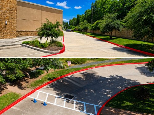 Red fire lane curb with NO PARKING / FIRE LANE stencil at a commercial building in Spring, TX
