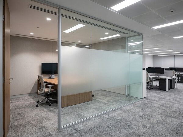 Glass office partition in a JLT workspace