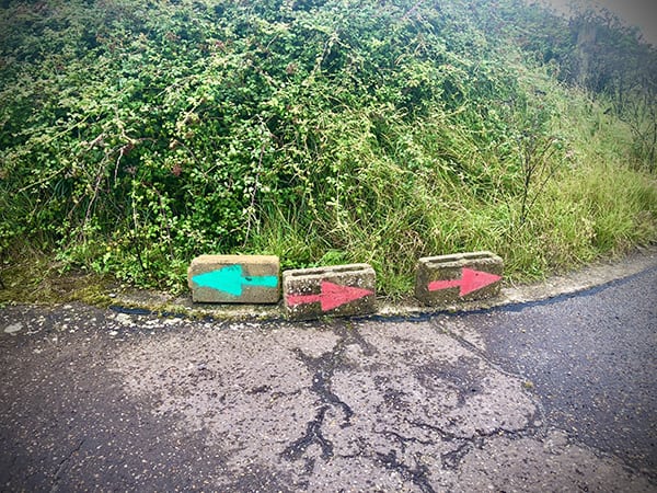 Example of low tech wayfinding design - Directional signs -painted arrows on bricks at Orford Ness